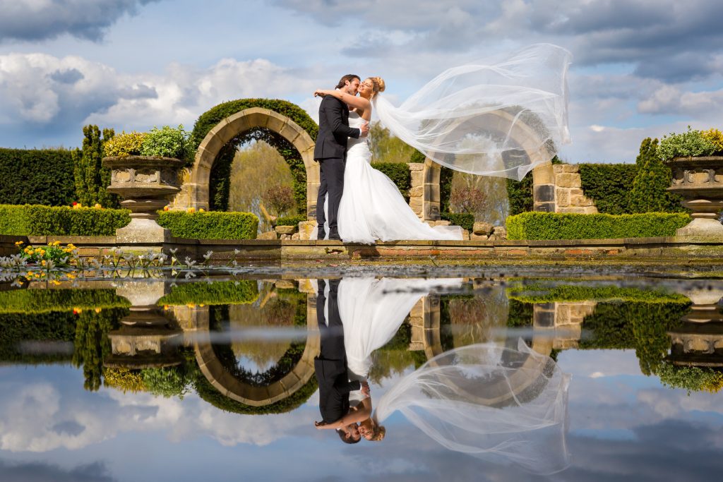 Husband and wife with sweeping veil image
