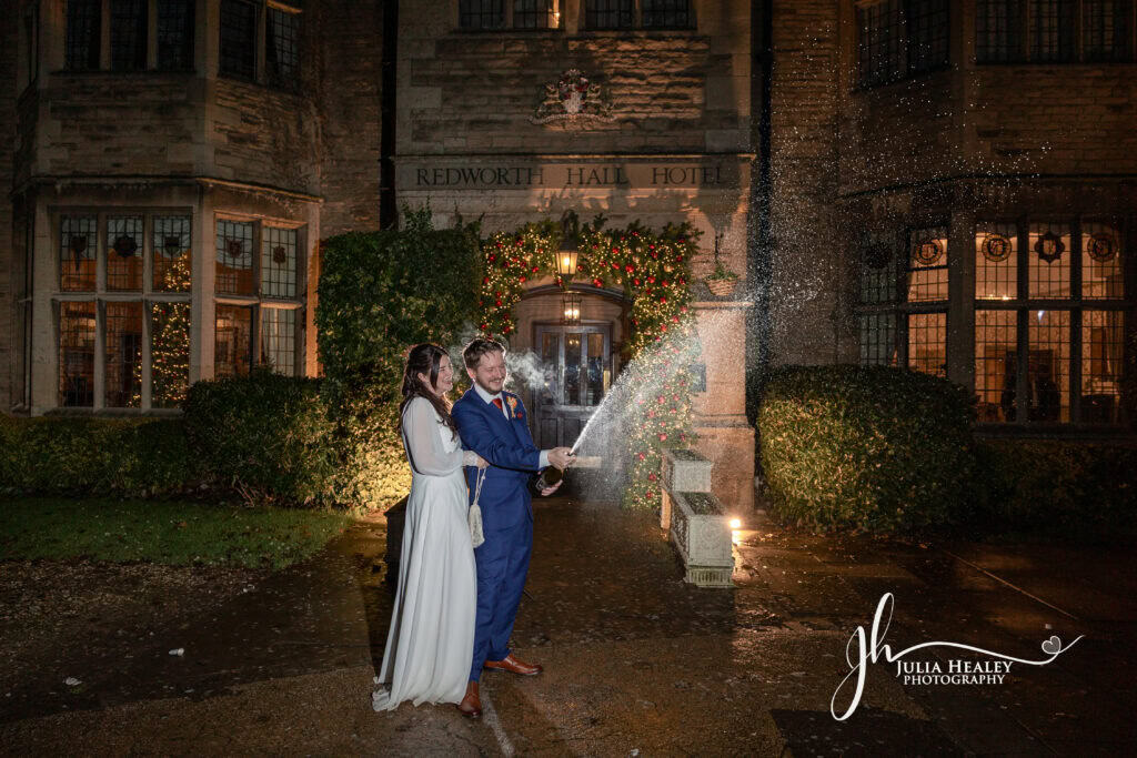 Couple celebrating with champagne at Redworth Hall Hotel