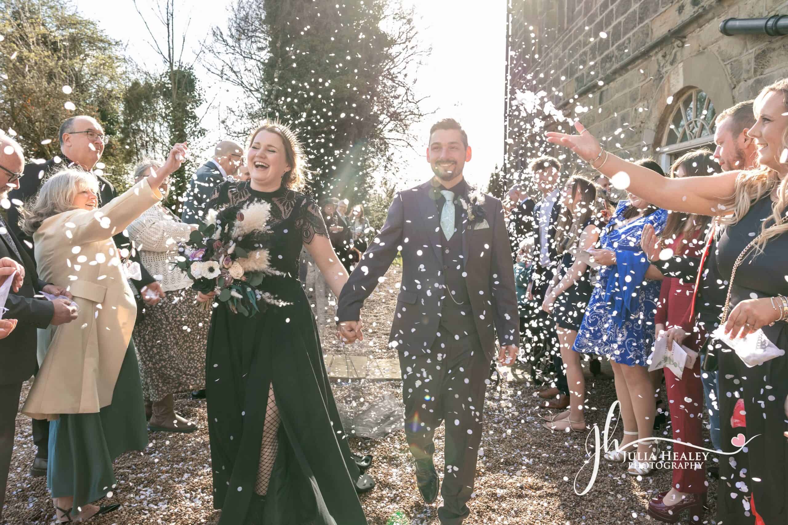 Wedding couple showered with confetti